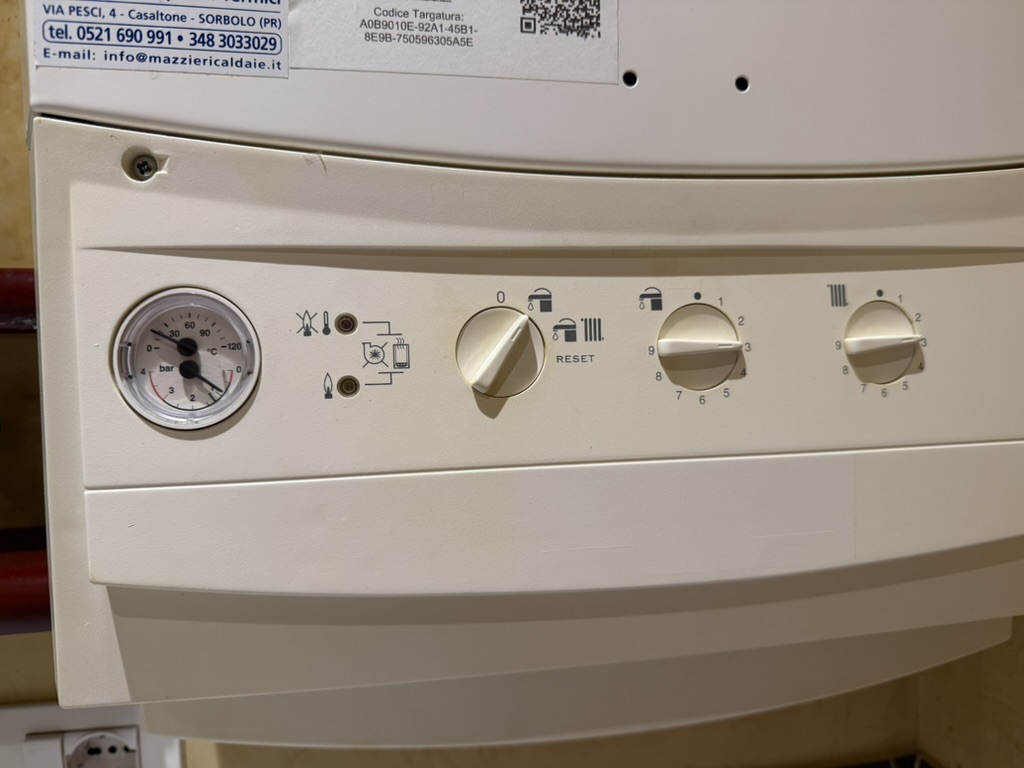 Boiler control panel with mode selector and heating dials.